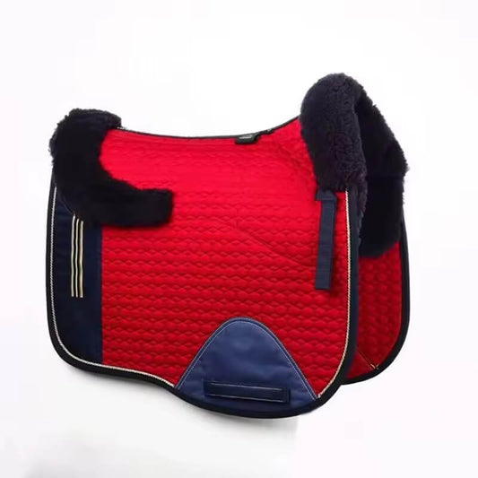 Red and navy saddle pad with black fleece lining on a white background