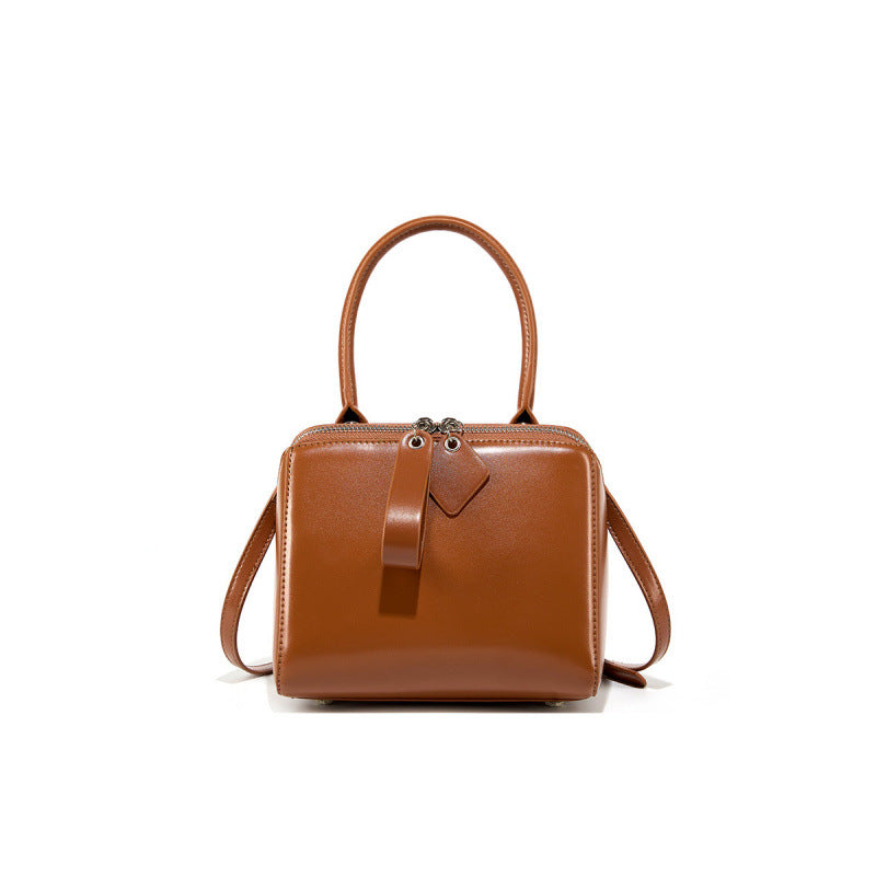 Brown leather handbag on a white background